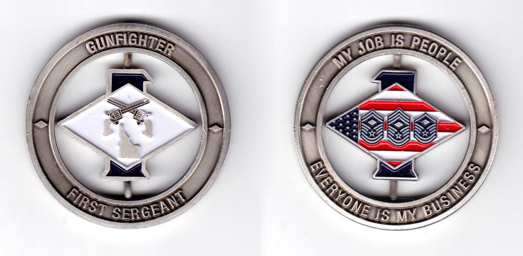 Round shaped, silver colored coin, 2 inches in diameter.