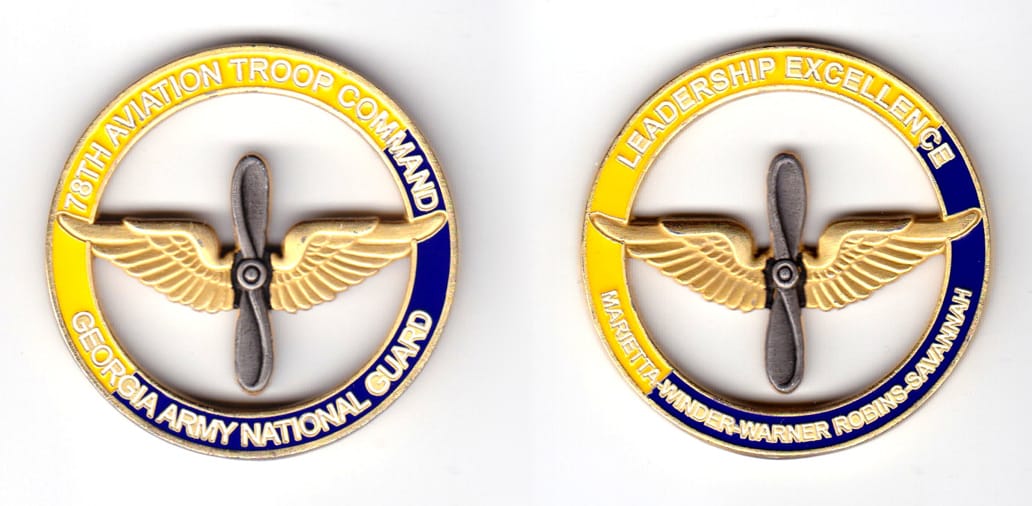 Round shaped, brass colored coin, 2 inches in diameter.