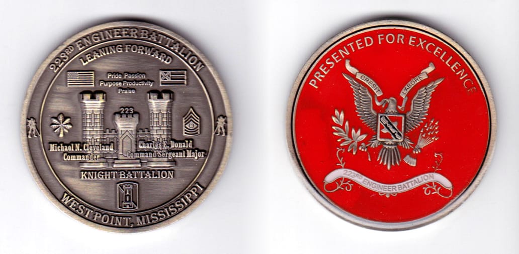 Round shaped, pewter colored coin, 2 inches in diameter.