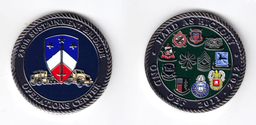 Round shaped, silver colored coin, 2 inches in diameter.