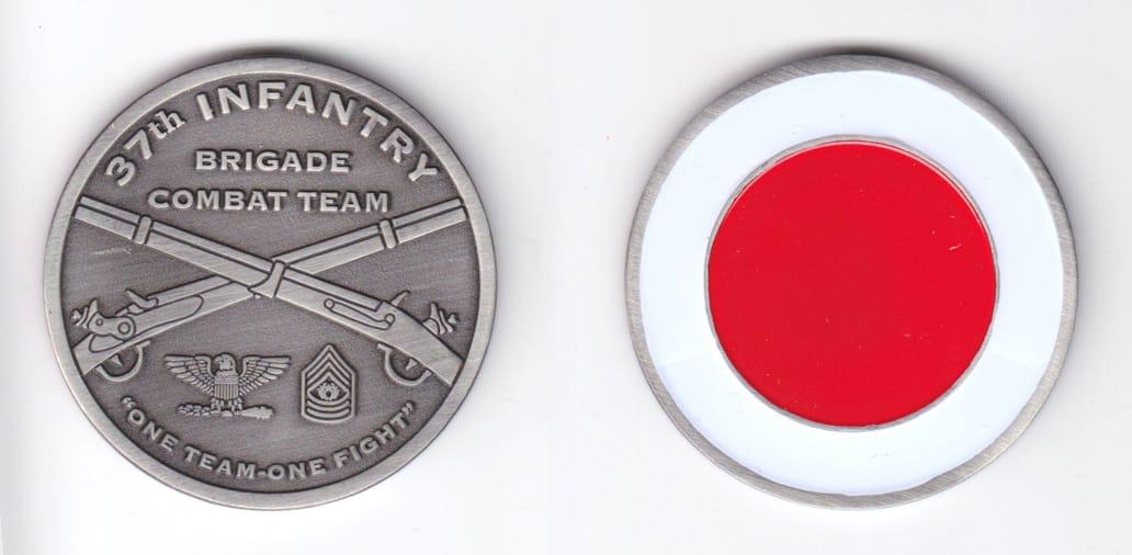 Round shaped, silver colored coin, 2 inches in diameter.