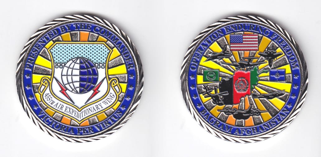 Round shaped, silver colored coin, 2 inches in diameter.