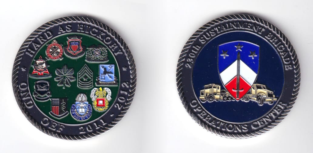 Round shaped, silver colored coin, 2 inches in diameter.