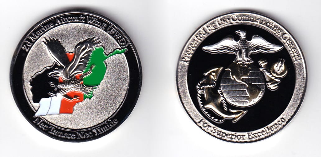 Round shaped, silver colored coin, 2 inches in diameter.