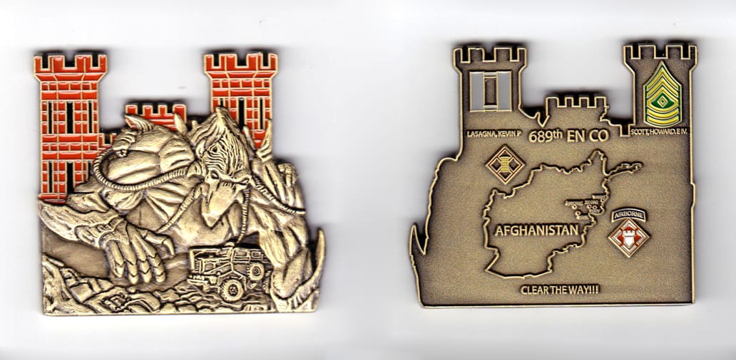 Engineer Castle with forground extending shaped, brass colored coin, 2-1/32  inches high x 2-15/64  inches wide.