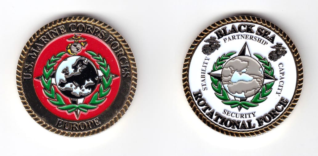 Round shaped coin, gold in color, 1 3/4 inches in diameter.