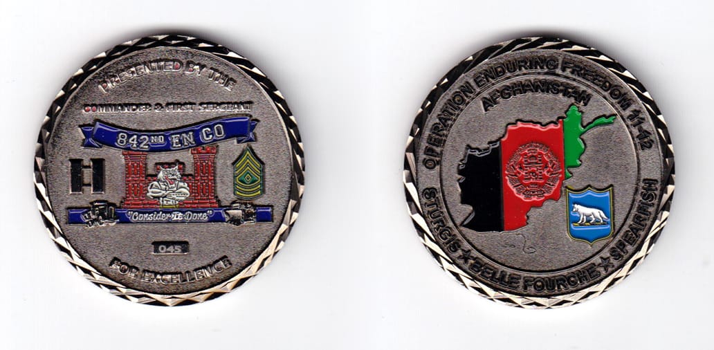 Round shaped coin, gun black in color, 1 3/4 inches in diameter.