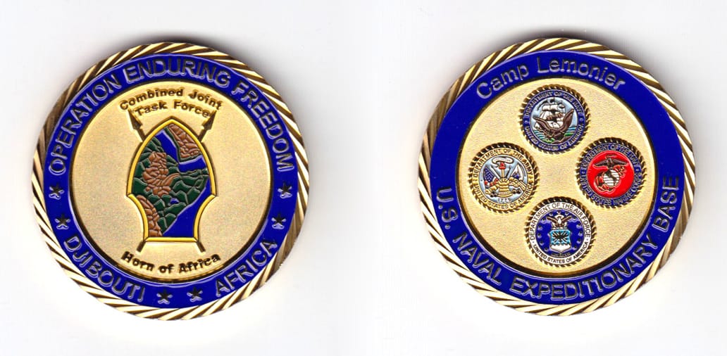 Round shaped coin, brass in color, 1 3/4 inches in diameter.