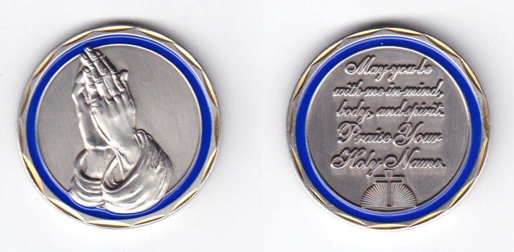 Round shaped coin, pewter in color, 1 5/8 inches in diameter.