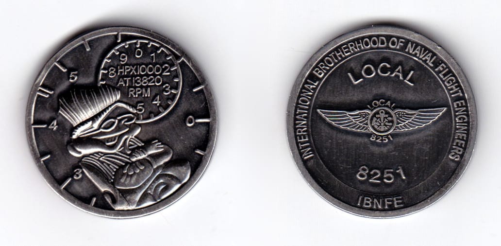 Round shaped, pewter colored coin, 1-5/8 inches in diameter.