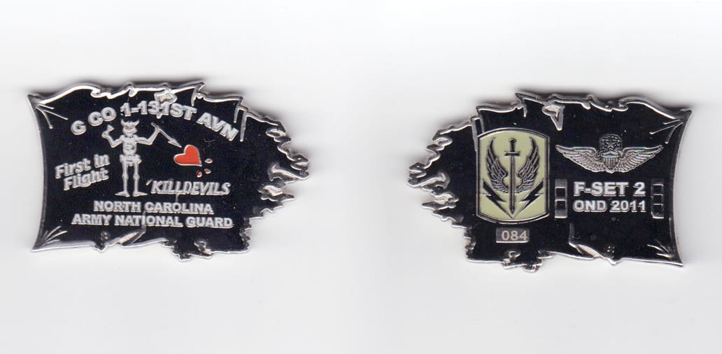 Coin shaped like a tattered flag, silver in color, 1 inch high x 2 inches wide.