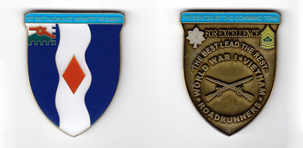 Shield shaped coin, antique brass in color, 2 1/4 inches high x 1 13/16 inches wide.