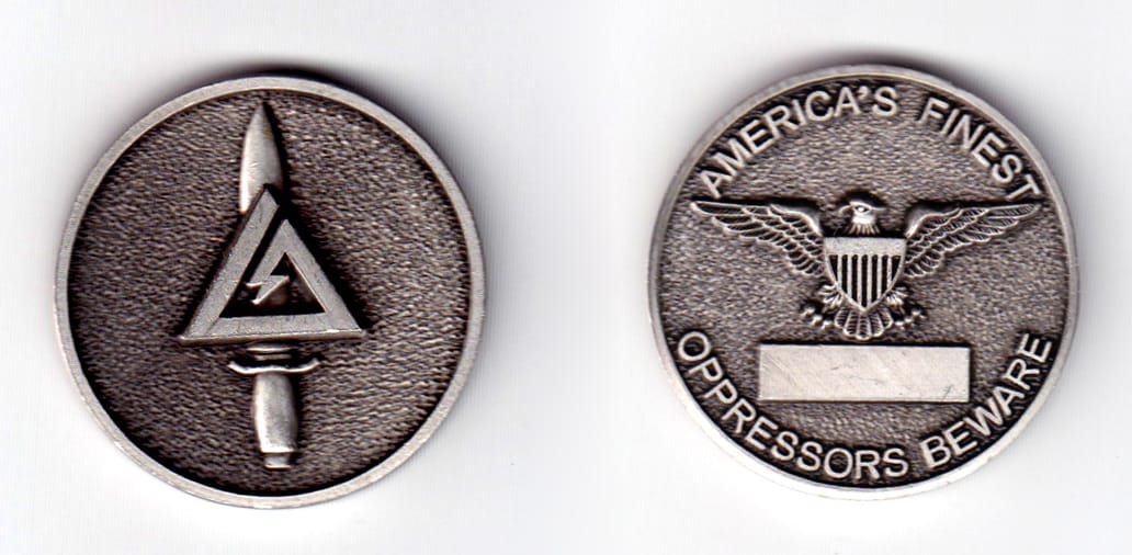 Round shaped coin, pewter in color, 1 31/64 inches in diameter.