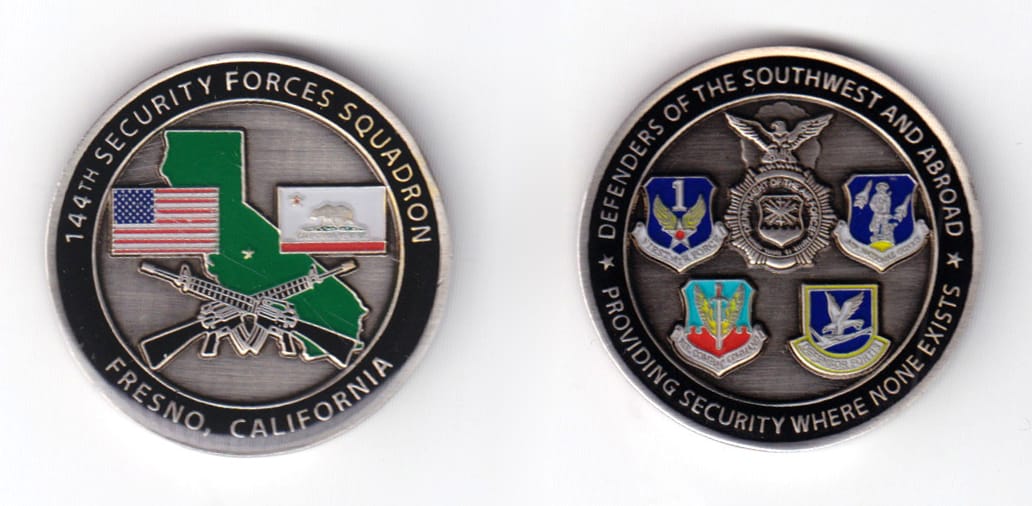 Round shaped coin, pewter in color, 1 9/16 inches in diameter.