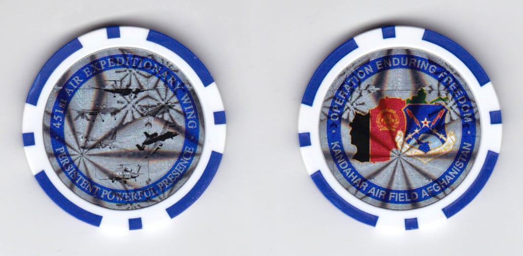 Round shaped poker chip, blue and white in color, 1 37/64 inches in diameter.