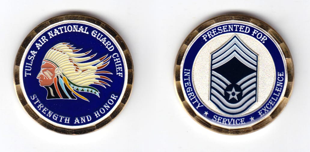 Round shaped coin, gold in color, 1 33/64 inches in diameter.