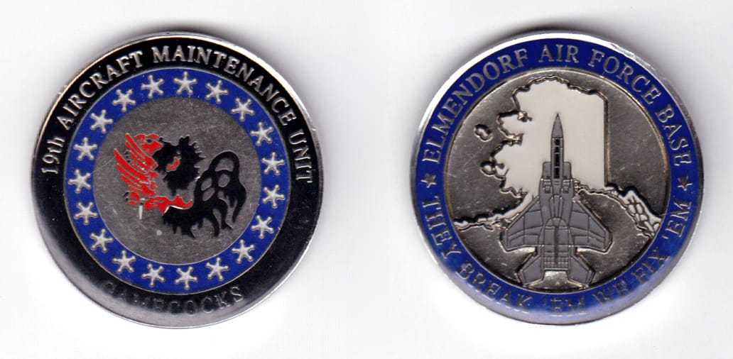 Round shaped coin, silver in color, 1 19/32 inches in diameter.