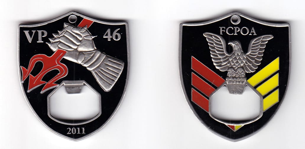 Shield shaped bottle opener, pewter in color, 2 1/2 inches high x 2 5/32 inches wide.