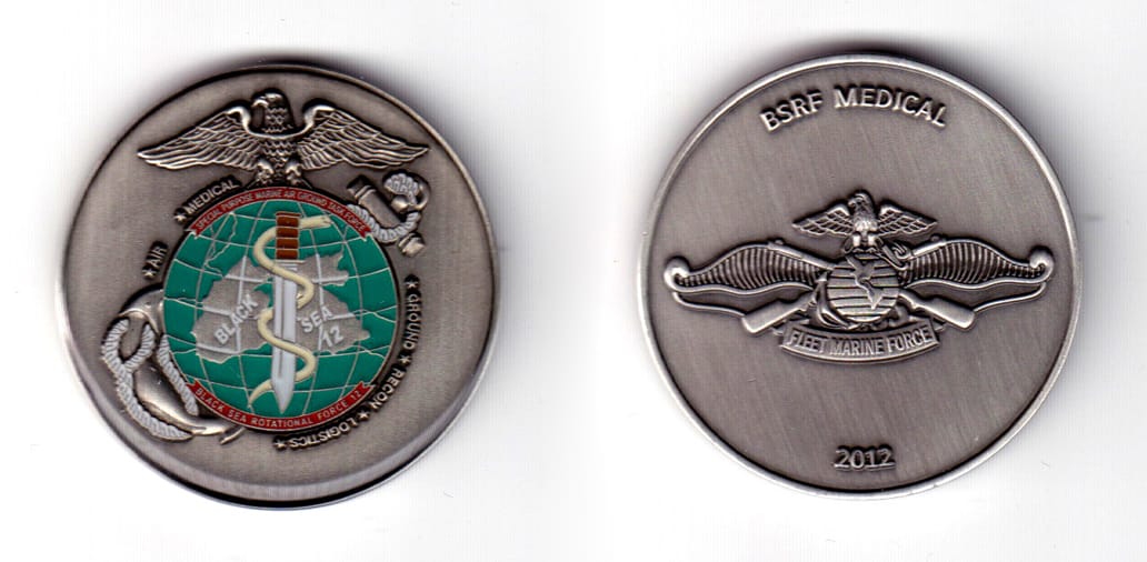 Round shaped coin, pewter in color, 1 47/64 inches in diameter.