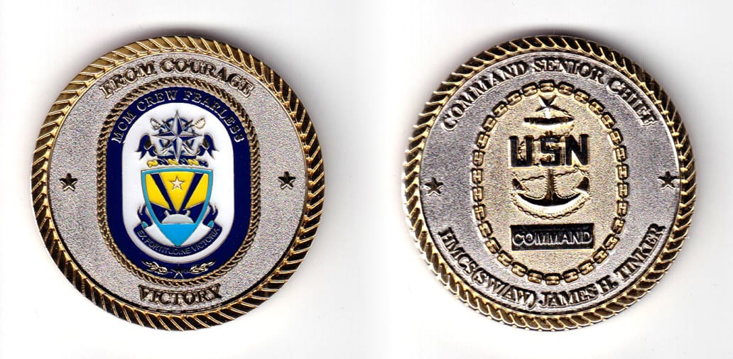 Round shaped coin, brass in color, 2 inches in diameter.