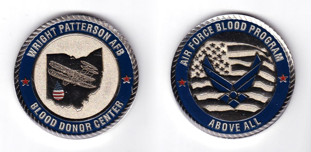 Round shaped coin, pewter in color, 2 inches in diameter.