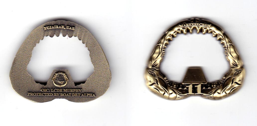 Bottle opener shaped, antique brass in color, 1 13/32 inches high x  1 49/64 inches wide.