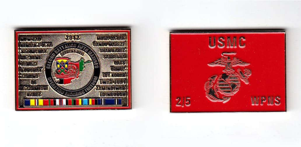 Rectanular shaped coin, brass in color, 1 25/64 inches high x 2 inches wide.