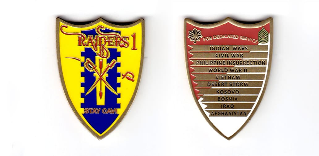 Shield shaped coin, pewter in color, 2 inches high x 1 31/64 inches wide.