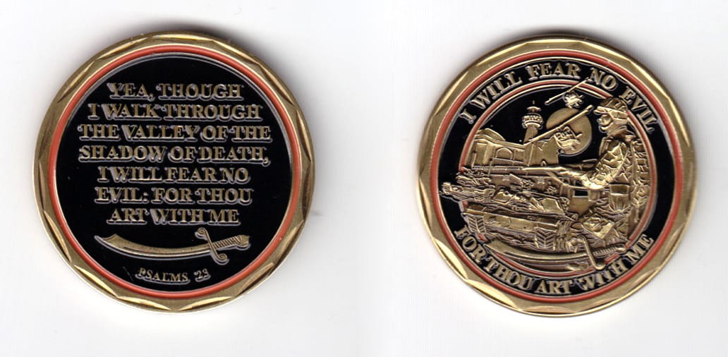 Round shaped coin, brass in color, 1 5/8 inches in diameter.