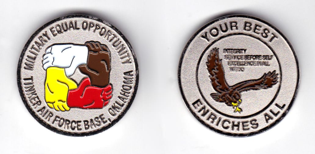 Round shaped coin, silver in color, 1 1/2 inches in diameter.