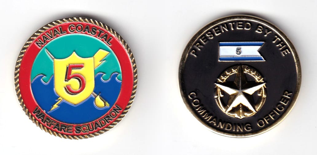 Round shaped coin, brass in color, 1 33/64 inches in diameter.