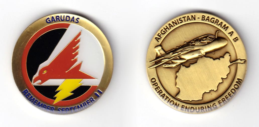 Round shaped coin, brass in color, 1 35/64 inches in diameter.