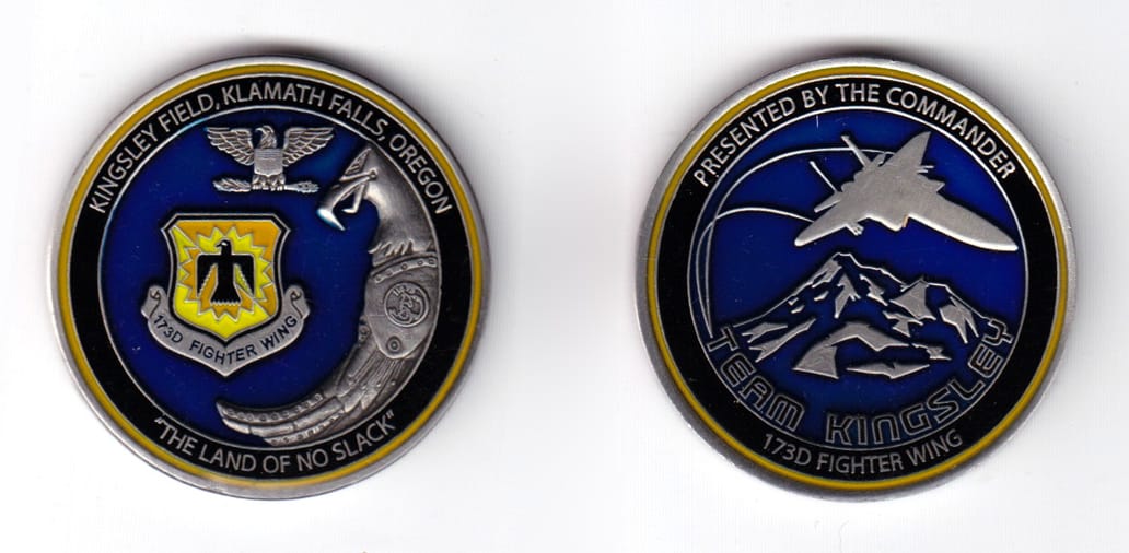 Round shaped coin, pewter in color, 1 47/64 inches in diameter.