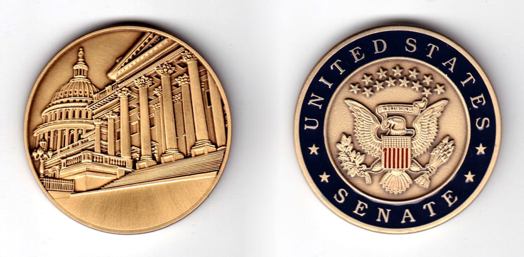 Round shaped coin, antique brass in color, 1 49/64 inches in diameter.