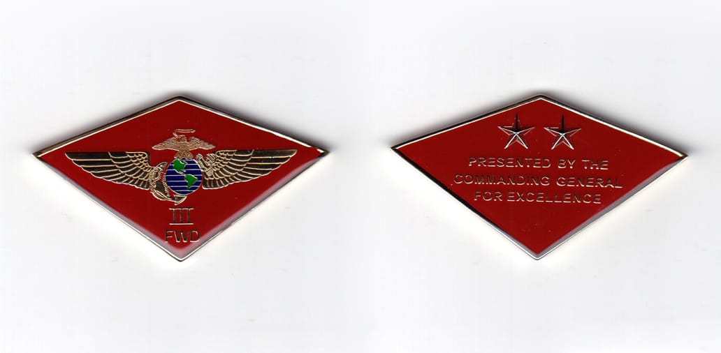 Diamond shaped coin, brass in color, 1 3/8 inches high x 2 17/32 inches wide.