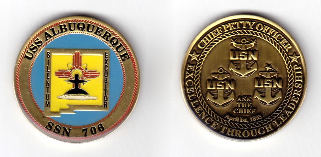 Round shaped coin, brass in color, 1 35/64 inches in diameter.