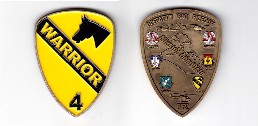 Shield shaped coin, brass in color, 2 37/6 inches high x 1 61/64 inches wide.