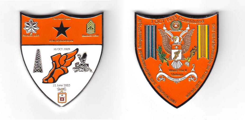 Shield shaped coin, pewter in color, 2 47/64 inches high  x 2 25/64 inches wide.