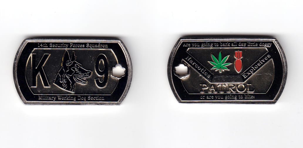 Dog tag shaped coin, pewter in color, 1 1/8th inches high x 2 inches wide.