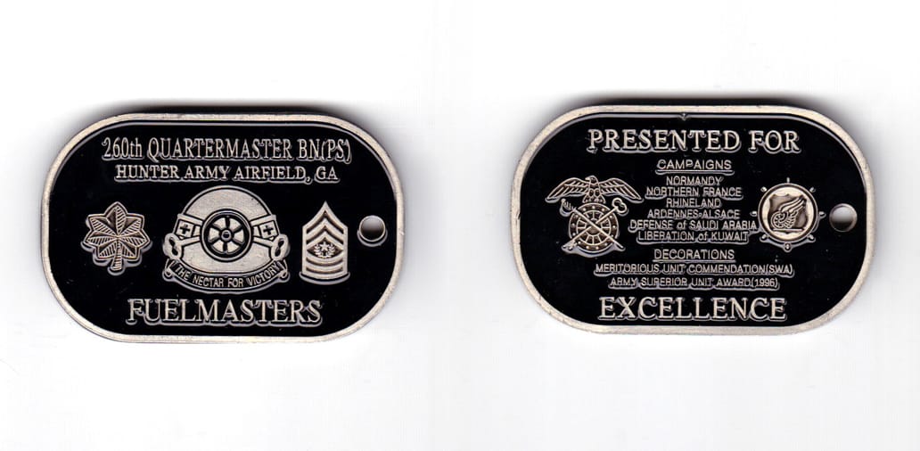 Dog tag shaped coin, antique pewter in color, 1 17/64 inches high x  2 inches wide.