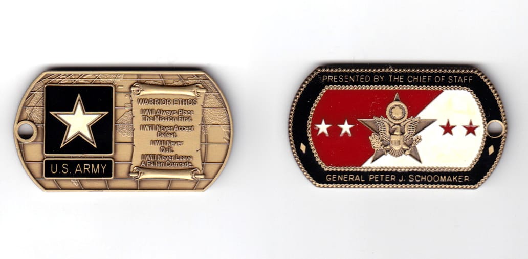 Dog tag shaped coin, antique brass in color, 1 11/64 inches high x   2 7/8 inches wide.