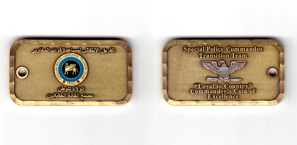 Dog tag shaped coin, antique brass in color, 1 11/64 inches high x    2 3/16 inches wide.