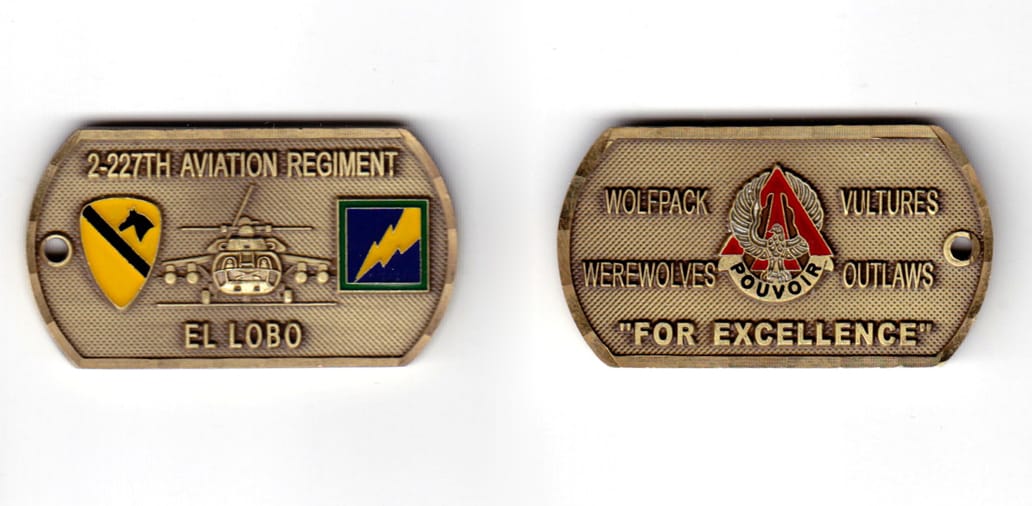 Dog tag shaped coin, antique brass in color, 1 3/32 inches high x     1 31/32 inches wide.