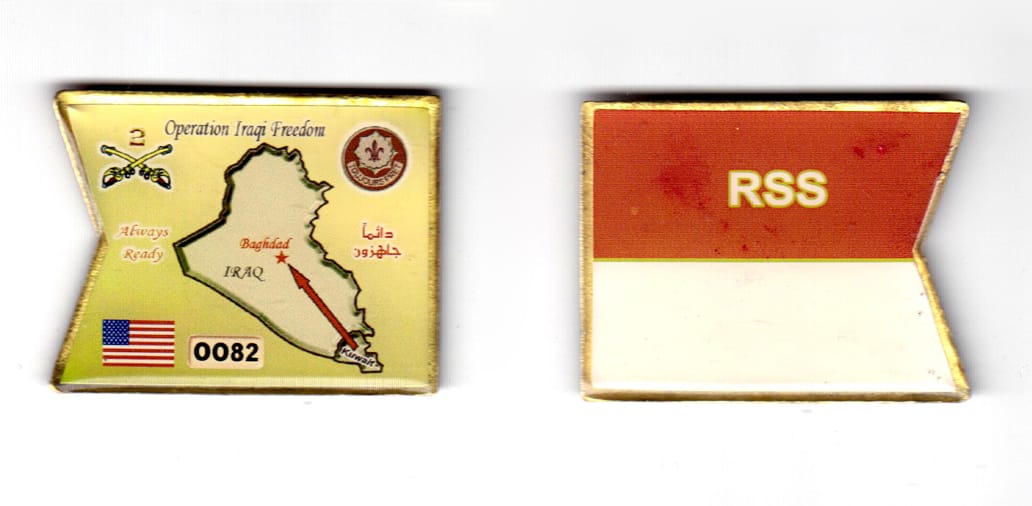 Swallowtail flag shaped, brass in color, 1 35/64 inches high x 2 inches wide.