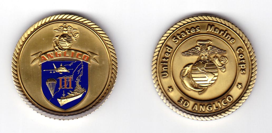 Round shaped coin, brass in color, 1 9/16 inches in diameter.