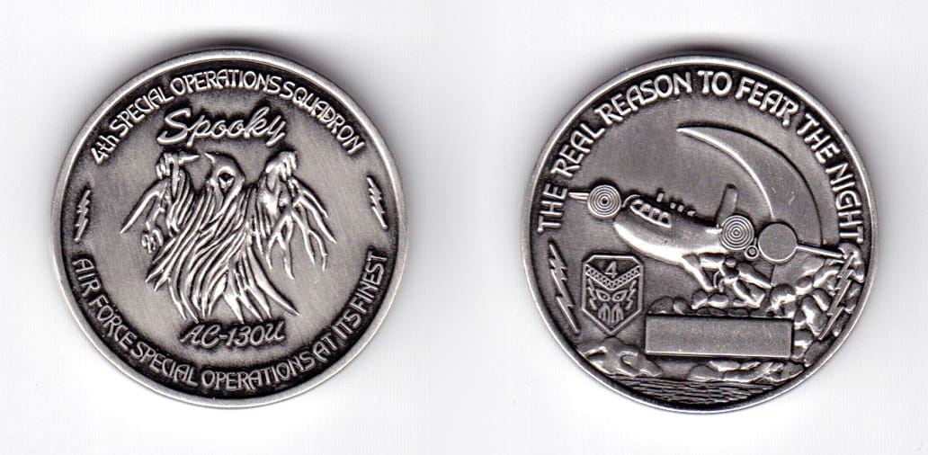 Round shaped coin, pewter in color, 1 1/2 inches in diameter.