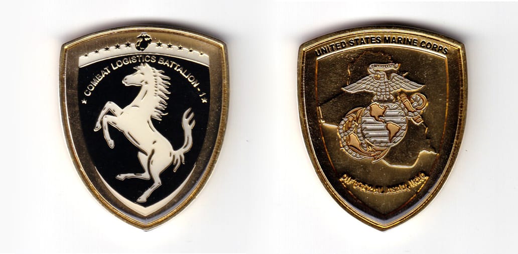 14th century heraldic shield shaped coin with slightly rounded top, brass in color, 2 inches high x 1 43/64 inches wide.