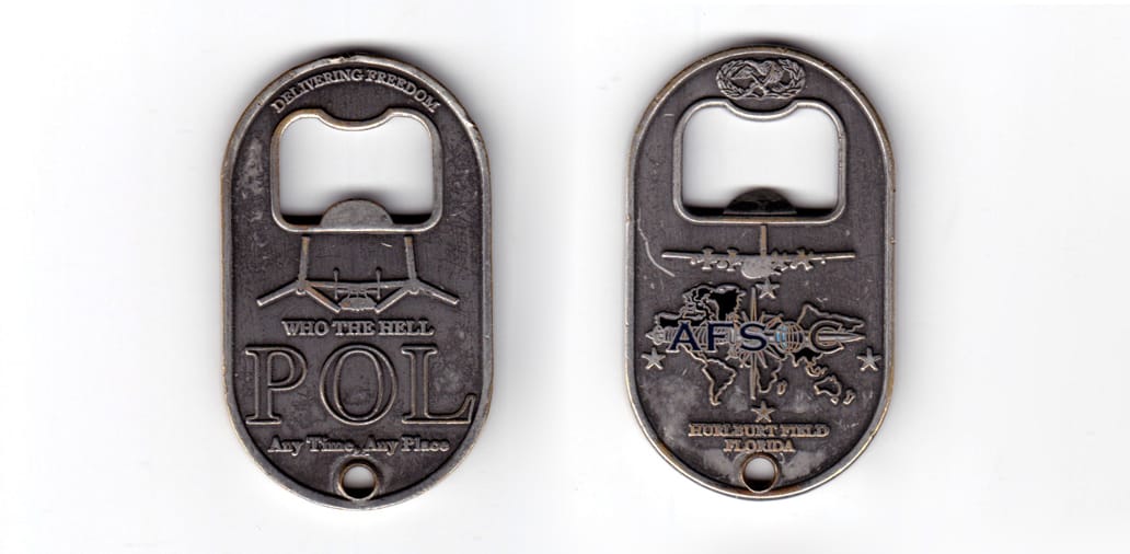 Dog tag shaped bottle opener, antique pewter in color, 2 33/64 inches high x 1 1/2 inches wide.