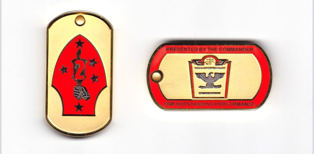 Dog tag shaped coin, gold in color, 2 1/8 inches high x 1 9/16 inches wide.