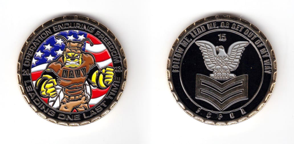 Round shaped coin, brass in color, 1 49/64 inches in diameter.